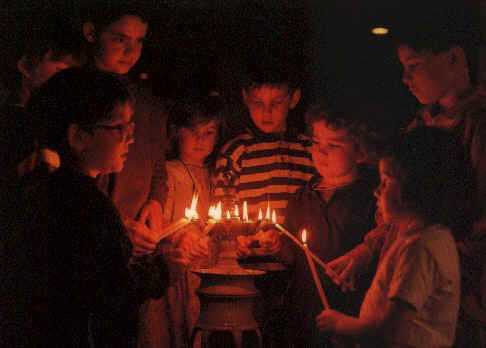 Children lighting the lights for the Saturday Evening Prayer Photograph S. Leutenegger (c) Ateliers et Presses de Taize